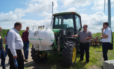 A tractor modified to run on a blend of diesel fuel and green ammonia.